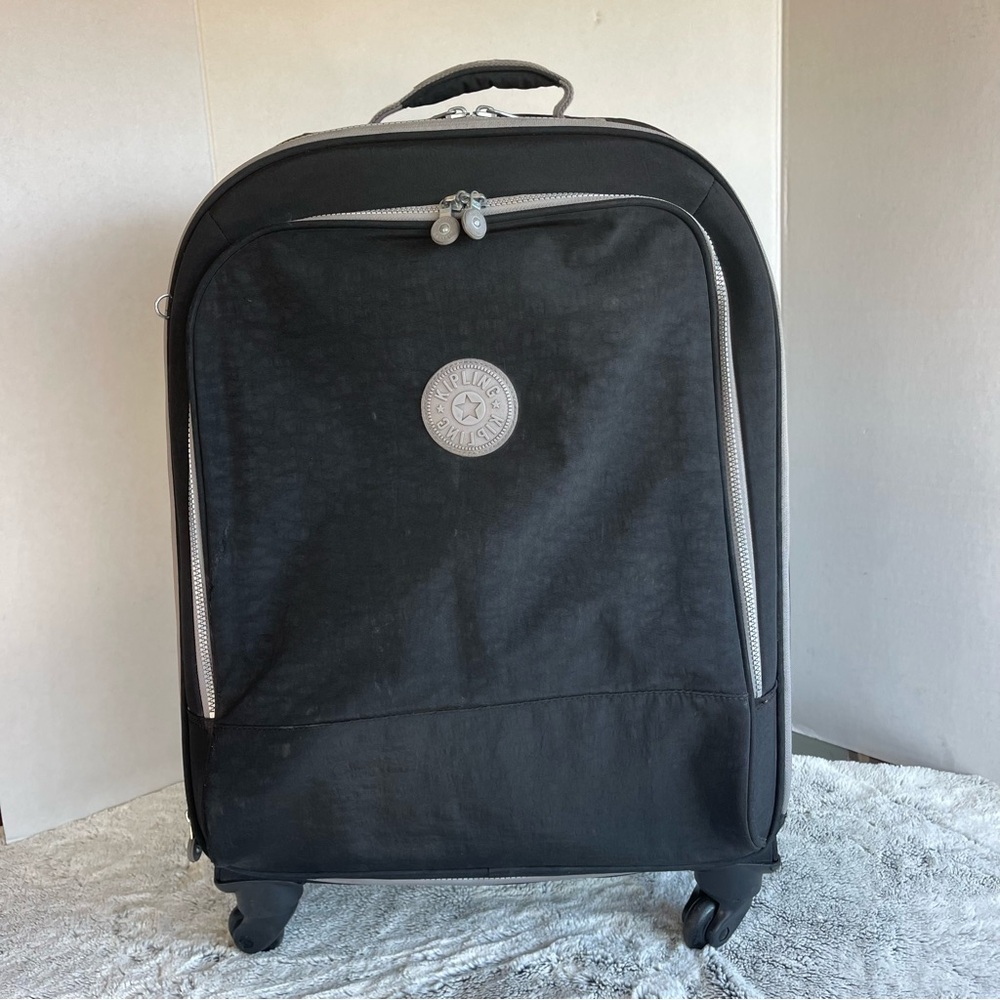 23” Kipling 4 wheels luggage Black and Grey Color.